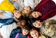 group-primary-schoolers-lying-ground-smiling